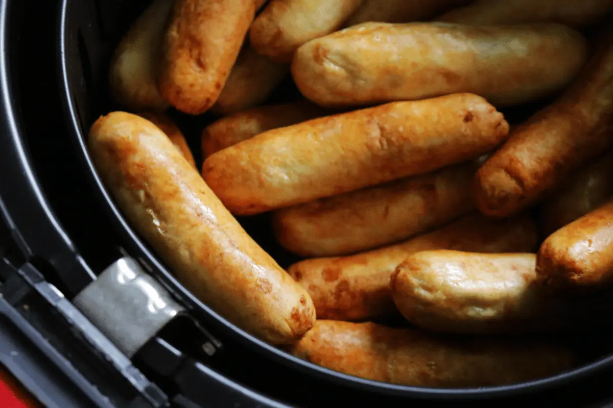 Savory Air Fryer Chicken Sausage Delight - A close-up of hot dogs cooking in an air fryer.