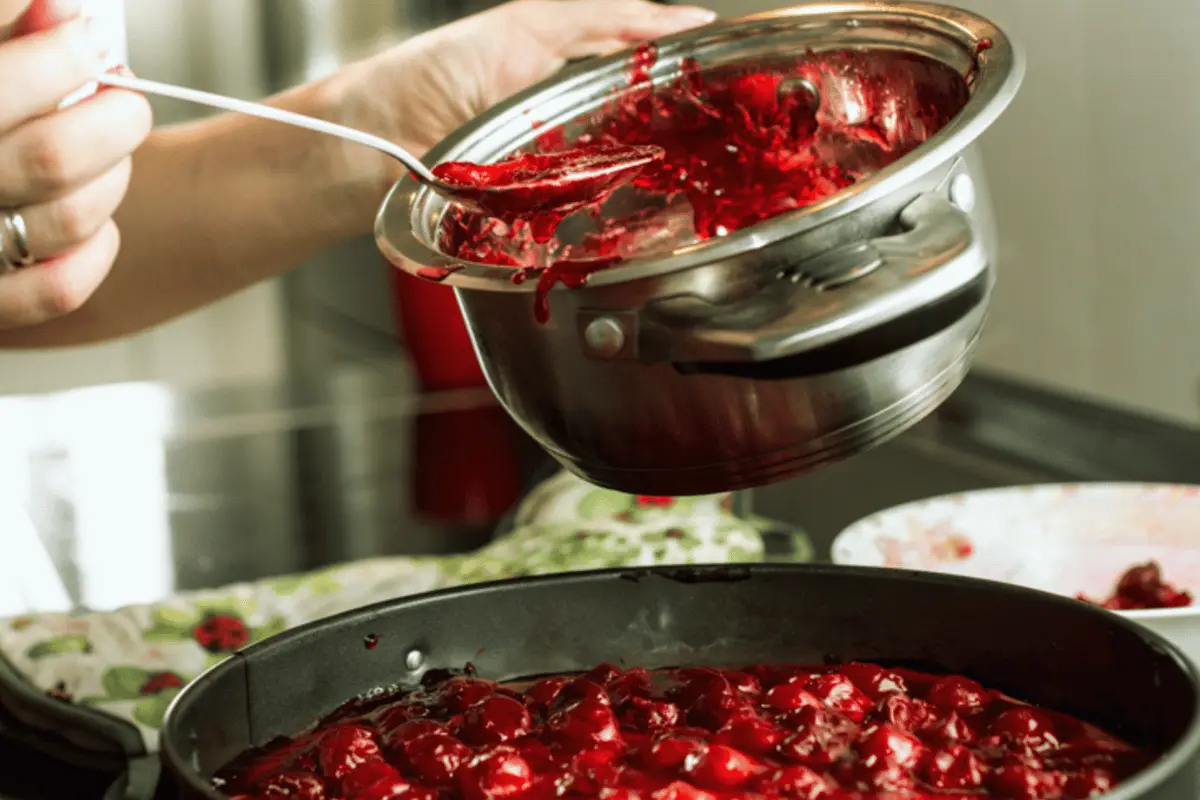 Sure Jell Jam-Making Session - A skilled person creating delicious homemade jam using Sure Jell Recipes.